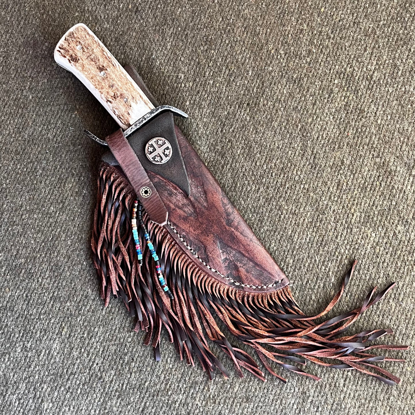 Custom Bowie Knife with Fringed Leather Sheath. Hand Forged in Montana.
