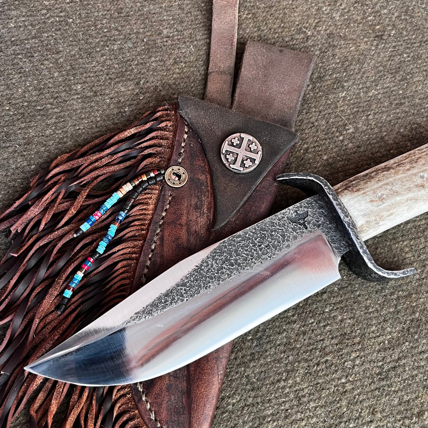 Custom Bowie Knife with Fringed Leather Sheath. Hand Forged in Montana.