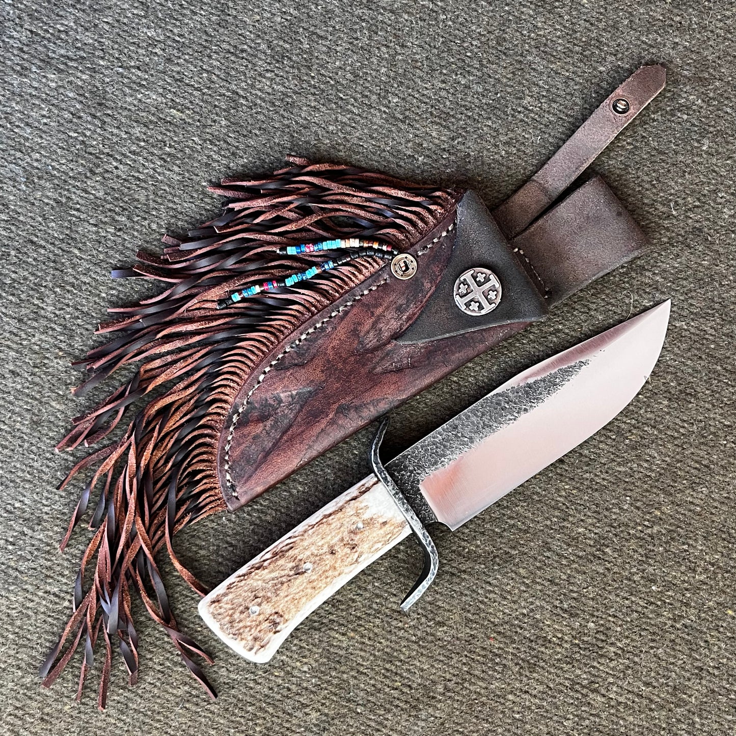 Custom Bowie Knife with Fringed Leather Sheath. Hand Forged in Montana.