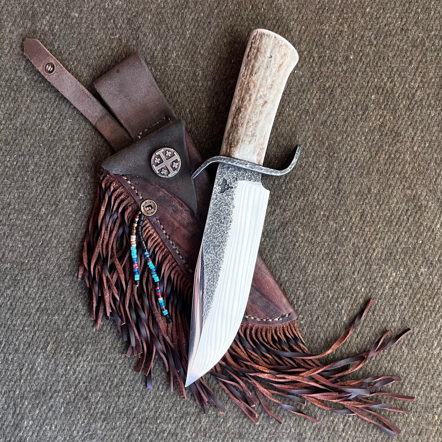 Custom Bowie Knife with Fringed Leather Sheath. Hand Forged in Montana.