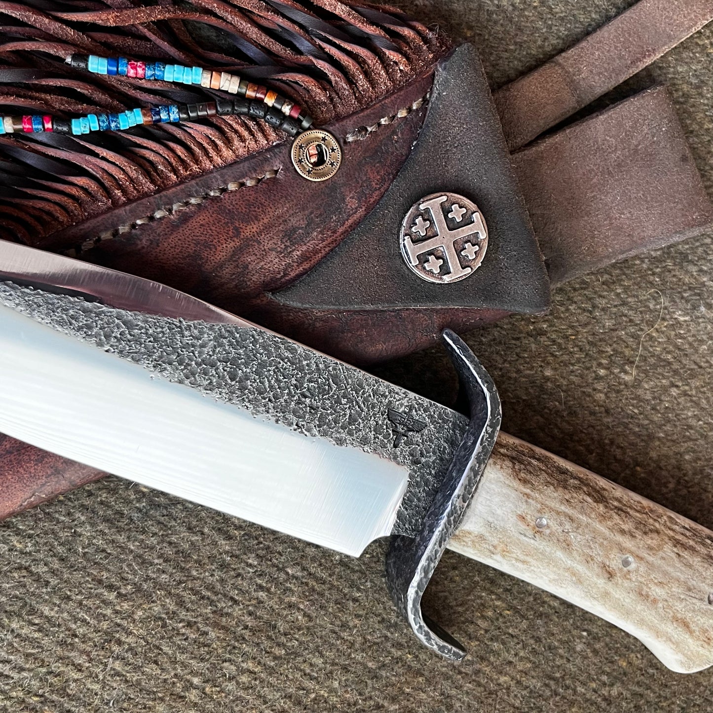 Custom Bowie Knife with Fringed Leather Sheath. Hand Forged in Montana.