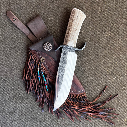 Custom Bowie Knife with Fringed Leather Sheath. Hand Forged in Montana.